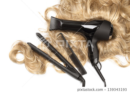 Blonde wavy hair with styling tools on white background Blonde wavy hair with styling tools on white background 139343193