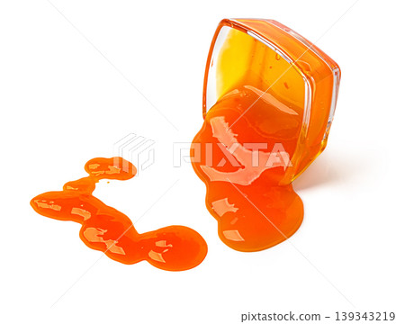 Orange jam spilling from a glass bowl 139343219