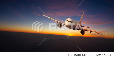 Commercial airplane flying during sunset with dramatic sky Commercial airplane flying during sunset with dramatic sky 139343224