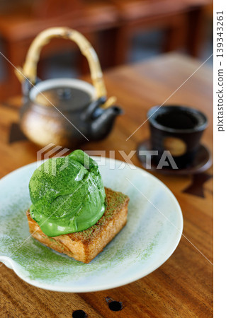 Scoop of matcha tea, green tea ice cream on toasted bread on wooden table. 139343261