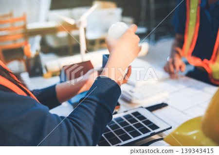 Concept Architect and desk of Architectural project in construction site or office building with mining light Concept Architect and desk of Architectural project in construction site or office building with mining light 139343415