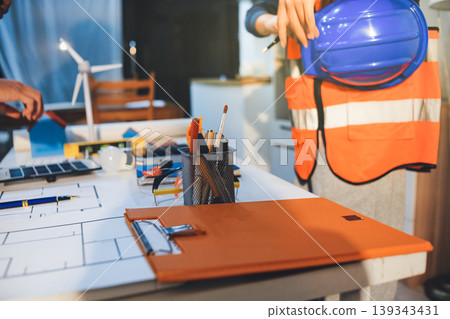 Concept Architect and desk of Architectural project in construction site or office building with mining light Concept Architect and desk of Architectural project in construction site or office building with mining light 139343431