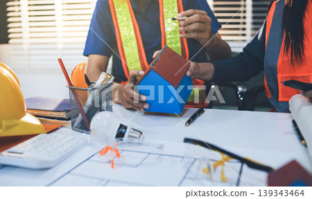 Concept Architect and desk of Architectural project in construction site or office building with mining light Concept Architect and desk of Architectural project in construction site or office building with mining light 139343464