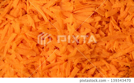 Grated carrots creating vibrant orange healthy food background 139343470