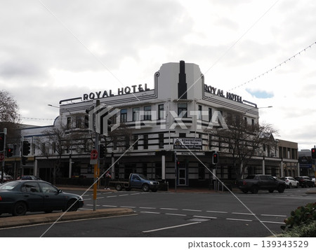 The imposing exterior of the Royal Hotel stands on an orange street corner – a scene of a historic intersection welcoming travelers. The imposing exterior of the Royal Hotel stands on an orange street corner – a scene of a historic intersection welcoming travelers. 139343529
