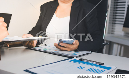 Accountants processing financial documents and taxes, managing corporate finance in a modern office. Audit and taxes in business 139343871