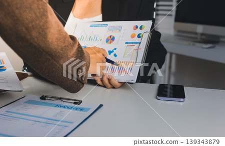 Accountants processing financial documents and taxes, managing corporate finance in a modern office. Audit and taxes in business Accountants processing financial documents and taxes, managing corporate finance in a modern office. Audit and taxes in business 139343879