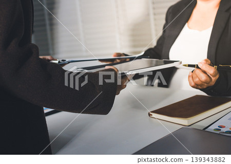 Accountants processing financial documents and taxes, managing corporate finance in a modern office. Audit and taxes in business Accountants processing financial documents and taxes, managing corporate finance in a modern office. Audit and taxes in business 139343882