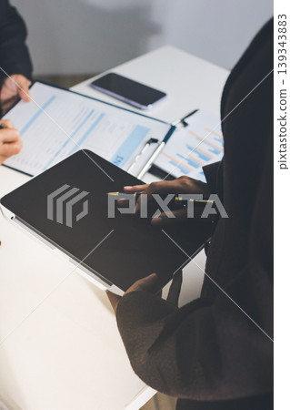 Accountants processing financial documents and taxes, managing corporate finance in a modern office. Audit and taxes in business Accountants processing financial documents and taxes, managing corporate finance in a modern office. Audit and taxes in business 139343883