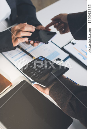 Accountants processing financial documents and taxes, managing corporate finance in a modern office. Audit and taxes in business Accountants processing financial documents and taxes, managing corporate finance in a modern office. Audit and taxes in business 139343885