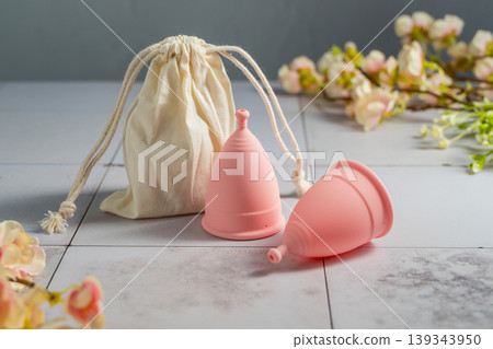 Menstrual cups. Pink feminine hygiene product. Women health concept. Menstrual cups. Pink feminine hygiene product. Women health concept. 139343950