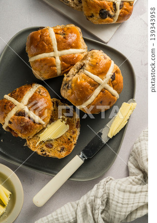 Cross Buns with butter in a plate. Breakfast concept. Top view. Easter treat buns Cross Buns with butter in a plate. Breakfast concept. Top view. Easter treat buns 139343958