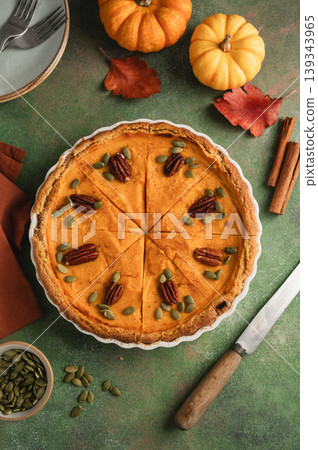Pumpkin pie, Thanksgiving homemade crust tart, topped with pecan nuts and seeds Pumpkin pie, Thanksgiving homemade crust tart, topped with pecan nuts and seeds 139343965
