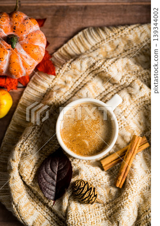 Hot drink, cosy autumn coffee drink, with apples and cinnamon, orange pumpkins, wooden rustic background Hot drink, cosy autumn coffee drink, with apples and cinnamon, orange pumpkins, wooden rustic background 139344002
