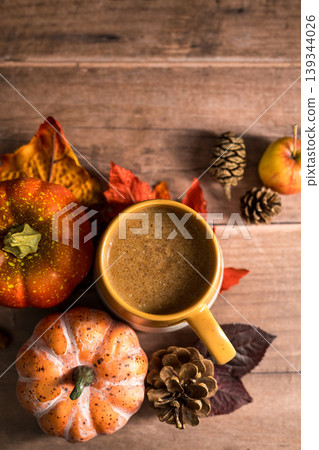 Hot drink, cosy autumn coffee drink, with apples and cinnamon, orange pumpkins, wooden rustic background Hot drink, cosy autumn coffee drink, with apples and cinnamon, orange pumpkins, wooden rustic background 139344026