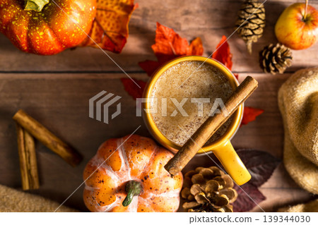 Autumn latte drink, cosy autumn coffee drink, orange pumpkin, cinnamon, wooden rustic background Autumn latte drink, cosy autumn coffee drink, orange pumpkin, cinnamon, wooden rustic background 139344030