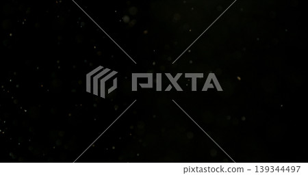 Close-up of floating dust particles in air, isolated on black background. Minimalist abstract texture with soft light, designed as VFX overlay for compositing. Close-up of floating dust particles in air, isolated on black background. Minimalist abstract texture with soft light, designed as VFX overlay for compositing. 139344497