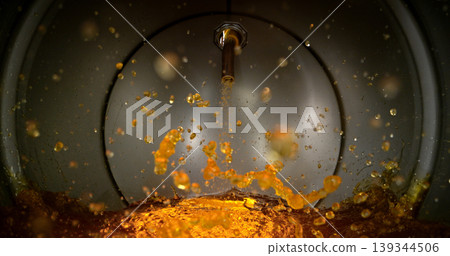 Gasoline jet pouring into metal fuel tank, inside view with dynamic splash and turbulence. Concept of refueling, fuel storage and energy supply, industrial environment. 139344506
