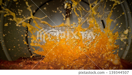 Gasoline jet pouring into metal fuel tank, inside view with dynamic splash and turbulence. Concept of refueling, fuel storage and energy supply, industrial environment. 139344507