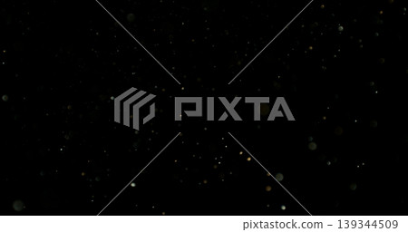 Close-up of floating dust particles in air, isolated on black background. Minimalist abstract texture with soft light, designed as VFX overlay for compositing. Close-up of floating dust particles in air, isolated on black background. Minimalist abstract texture with soft light, designed as VFX overlay for compositing. 139344509