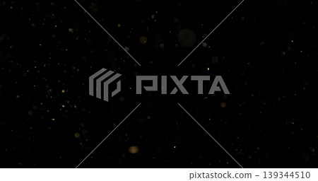 Close-up of floating dust particles in air, isolated on black background. Minimalist abstract texture with soft light, designed as VFX overlay for compositing. Close-up of floating dust particles in air, isolated on black background. Minimalist abstract texture with soft light, designed as VFX overlay for compositing. 139344510