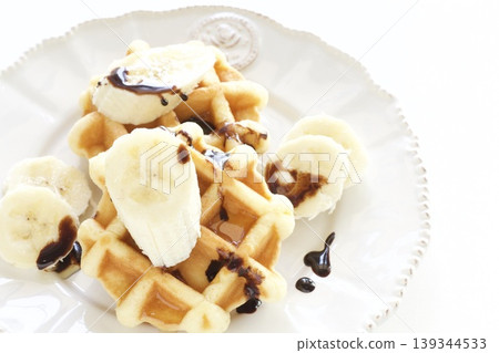 Belgian waffles topped with bananas Belgian waffles topped with bananas 139344533