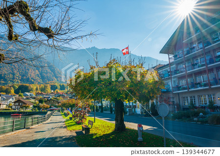 Autumn scenery on the shores of Lake Brienz with a wooden bench by the water. Benningen, Canton of Bern, Switzerland Autumn scenery on the shores of Lake Brienz with a wooden bench by the water. Benningen, Canton of Bern, Switzerland 139344677