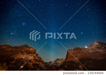 The Milky Way shines brightly above the Eiger ridge in Grindelwald on an autumn night. Grindelwald, Bern Canton, Switzerland The Milky Way shines brightly above the Eiger ridge in Grindelwald on an autumn night. Grindelwald, Bern Canton, Switzerland 139344694