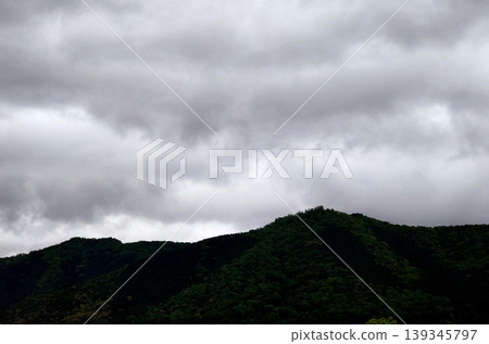 Mountain ranges covered in thick clouds and a cloudy landscape Mountain ranges covered in thick clouds and a cloudy landscape 139345797