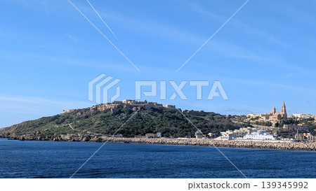 Panoramic view of the mountain side of Gozo island taken from offshore Panoramic view of the mountain side of Gozo island taken from offshore 139345992