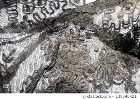Close up of vintage black gothic lace fabric white on black background embroidery 139346421