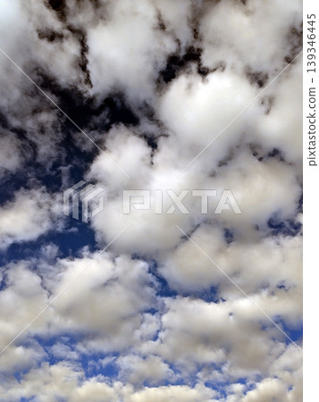 Moody white clouds across a blue black sky change in weather skyscape Moody white clouds across a blue black sky change in weather skyscape 139346445