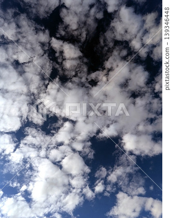 Moody white clouds across a blue black sky change in weather skyscape Moody white clouds across a blue black sky change in weather skyscape 139346448