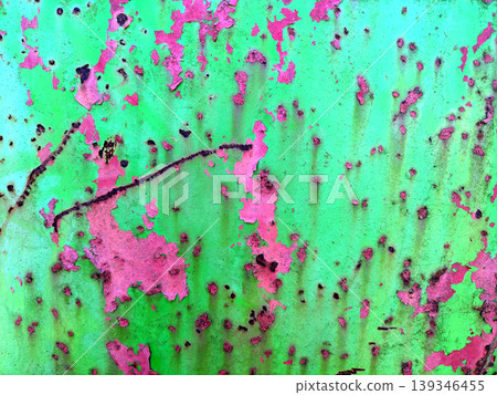 Close up of aged distressed chipped rusted paint work on a wall in green and red 139346455