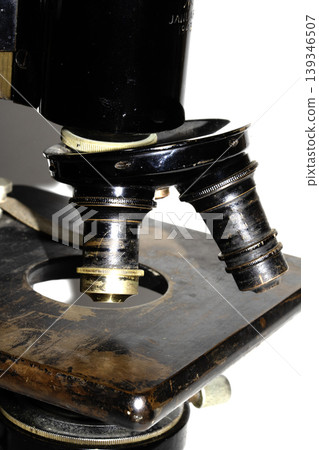 A used vintage microscope from the army on white background A used vintage microscope from the army on white background 139346507