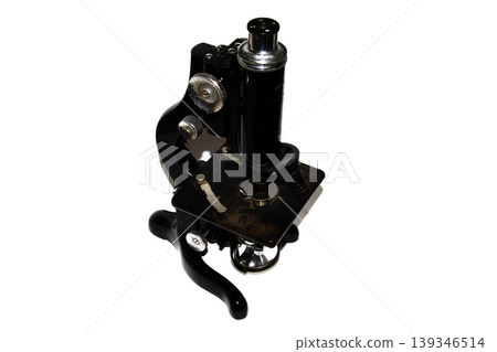 A used vintage microscope from the army on white background 139346514