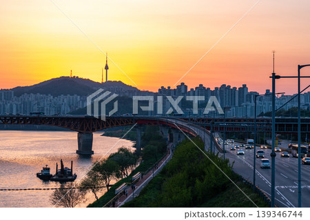 Seoul, South Korea - Apr. 24, 2026 : Sunset Cityscape of Seoul with N Seoul Tower, Seongsu Bridge and Busy Traffic on Gangbyeonbukro Highway 139346744