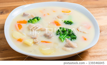 Cream stew, a hearty chicken and vegetable stew, wooden table Cream stew, a hearty chicken and vegetable stew, wooden table 139346845