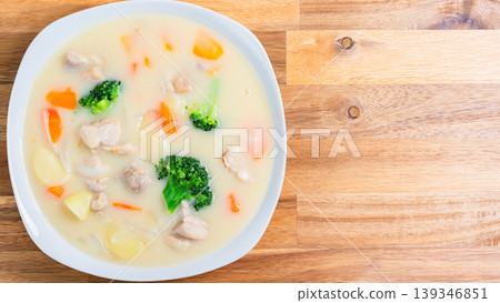 Cream stew, a hearty chicken and vegetable stew, wooden table 139346851