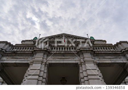 The facade of the Akasaka Palace State Guest House, standing under a cloudy sky. 139346858