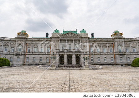 The facade of the Akasaka Palace State Guest House, standing under a cloudy sky. 139346865