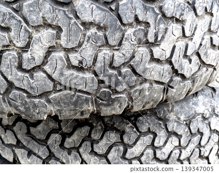 Close up of patterned tire car wheel tracks abstract background 139347005