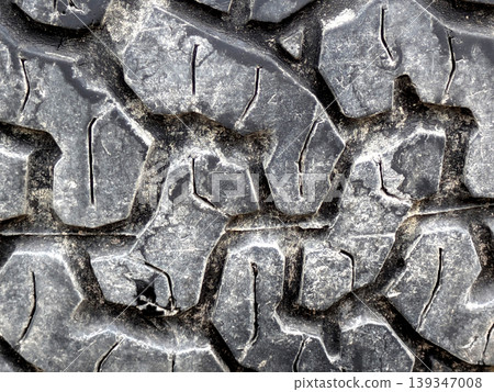 Close up of patterned tire car wheel tracks abstract background Close up of patterned tire car wheel tracks abstract background 139347008