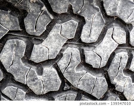 Close up of patterned tire car wheel tracks abstract background Close up of patterned tire car wheel tracks abstract background 139347010