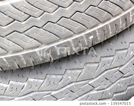Close up of patterned tire car wheel tracks abstract background Close up of patterned tire car wheel tracks abstract background 139347015
