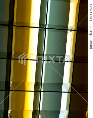 Directional LED lights on rails under the ceiling abstract lines in orange and white Directional LED lights on rails under the ceiling abstract lines in orange and white 139347024