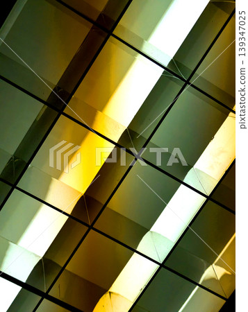 Directional LED lights on rails under the ceiling abstract lines in orange and white Directional LED lights on rails under the ceiling abstract lines in orange and white 139347025