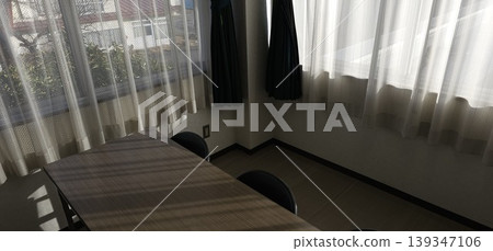 A classroom bathed in natural light, with desks neatly arranged. 139347106