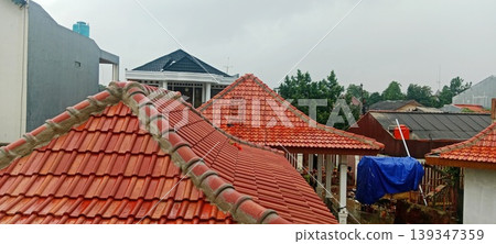 Row of Red Tile Roofs in a Residential Area 139347359