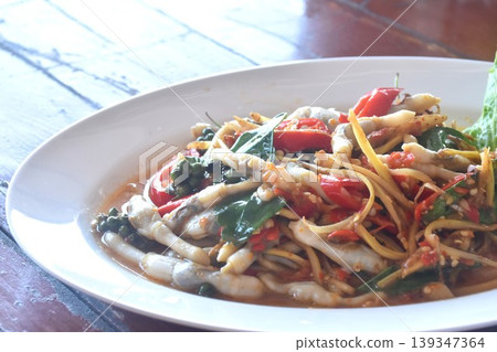 spicy fried razor clam with chili and slice finger root couple basil topping fresh pepper on plate spicy fried razor clam with chili and slice finger root couple basil topping fresh pepper on plate 139347364